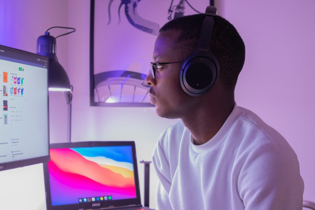 man in white crew neck shirt wearing black headphones