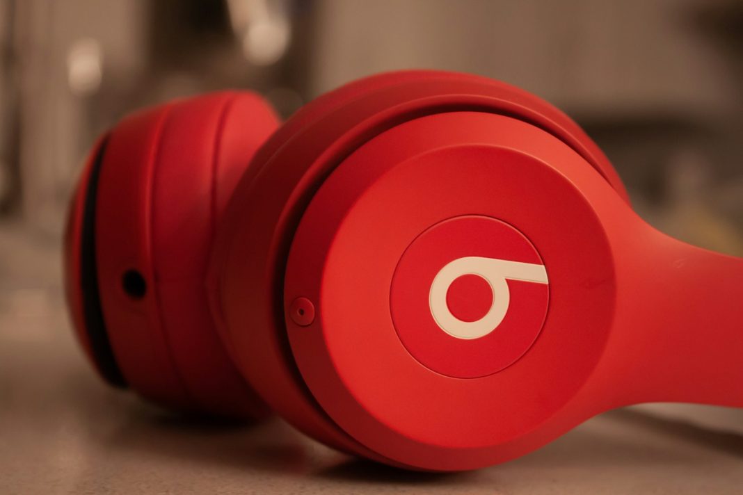 a pair of red headphones sitting on top of a counter