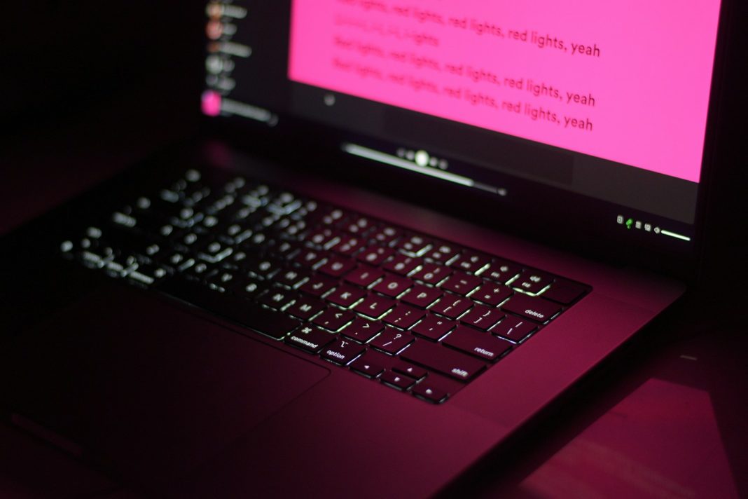 a close up of a laptop with a pink screen